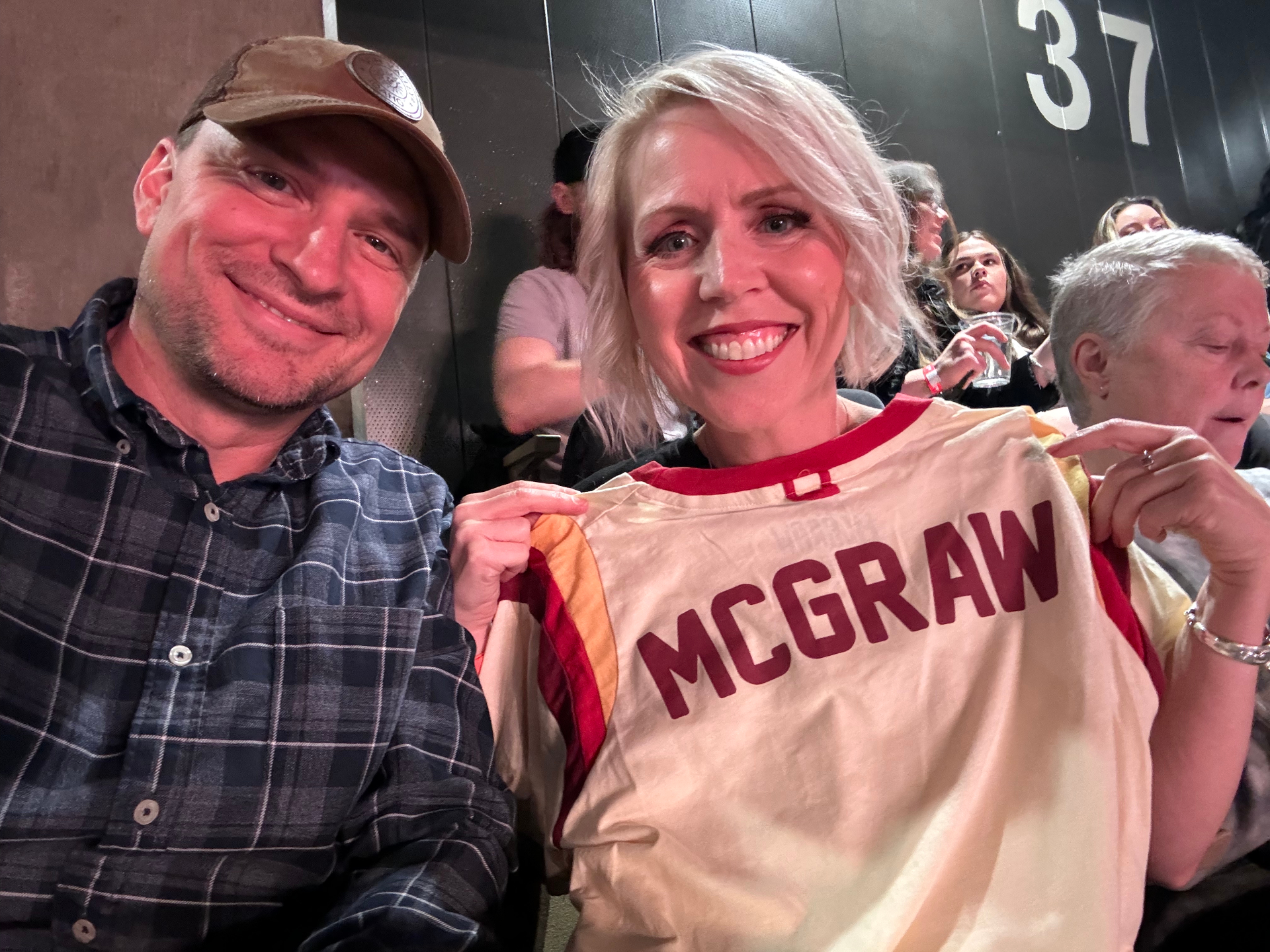 Holding a Tim McGraw t-shirt at an event