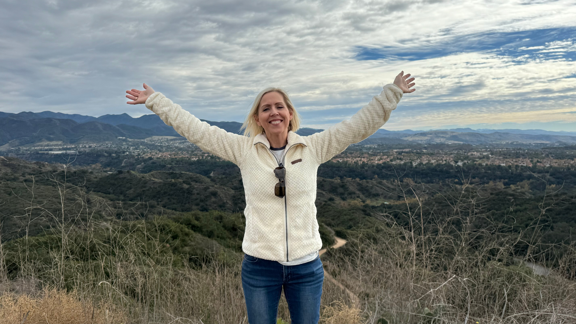 Standing on cliff with arms wide
